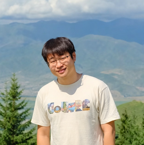 Xiufeng Li outdoors in front of a mountain landscape